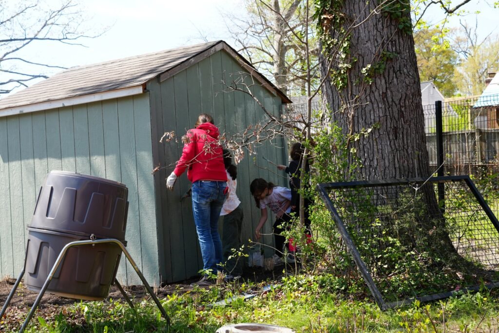 Parents working at the garden shed and rain barrels on a workday