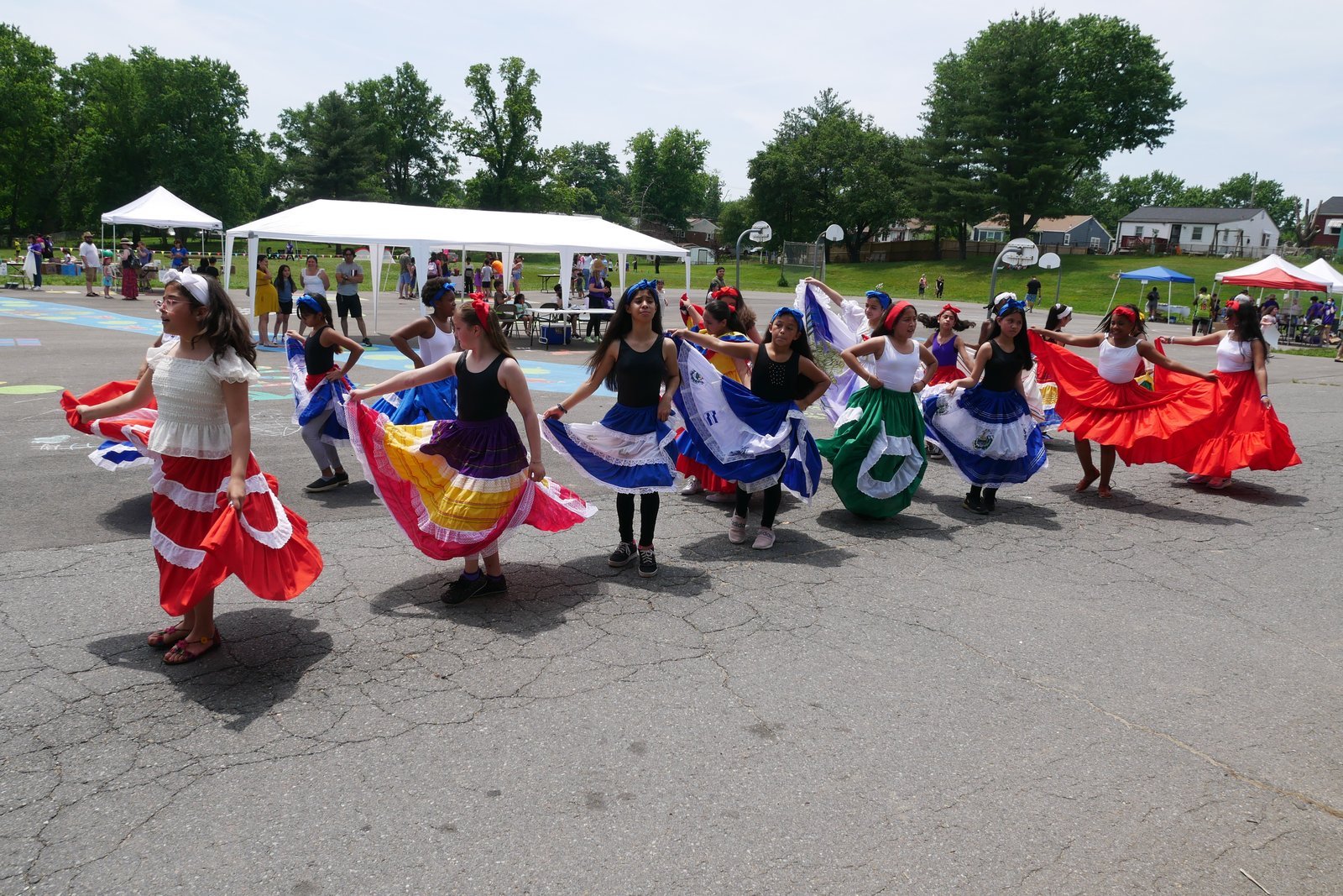 Student dancers performing in costume at the ¡Sí Se Puede! festival